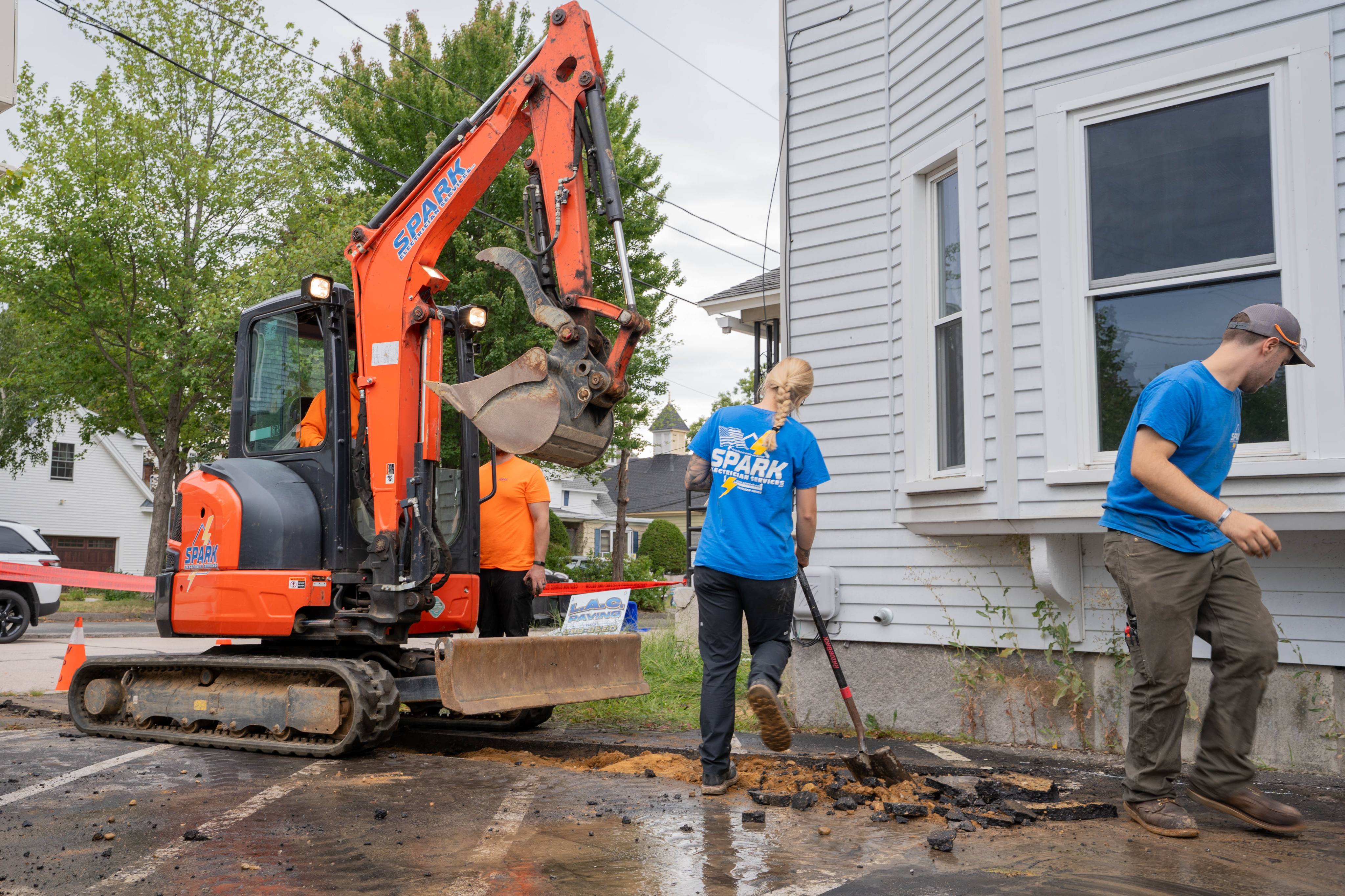 Excavating the service trench along the building