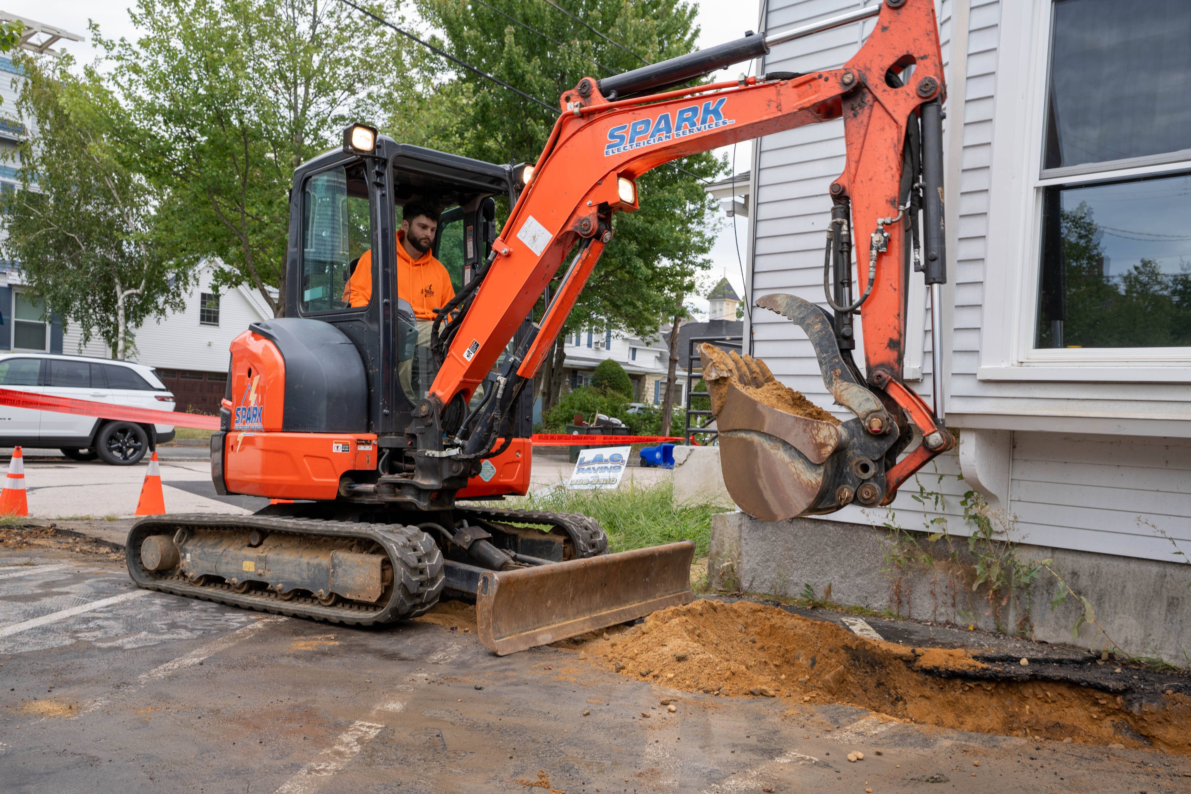 Excavating the service trench along the building
